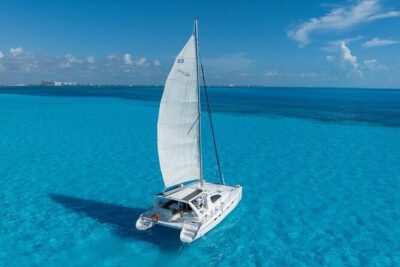 Isla Mujeres Day Tour with Catamaran, Snorkeling & Beach Club - Catamaran Ride and Open Bar: Fun Energy, Not a Quiet Retreat